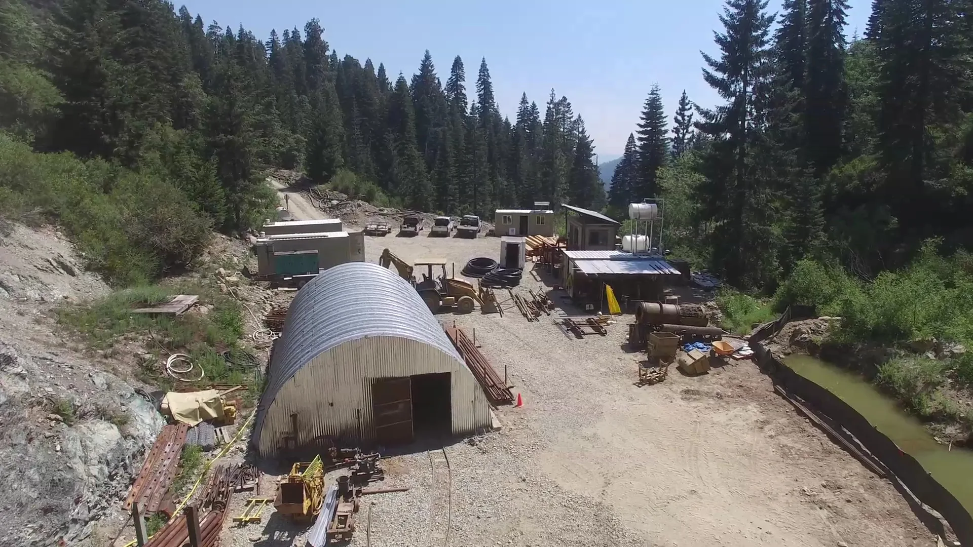 Site facilities framed by the surrounding mountain forest.