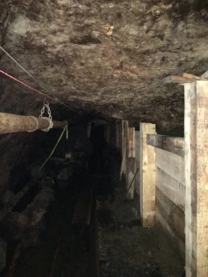 Underground passage showing timberwork and rock conditions.